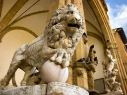 Løveskulptur i marmor omgivet af kunstneriske detaljer