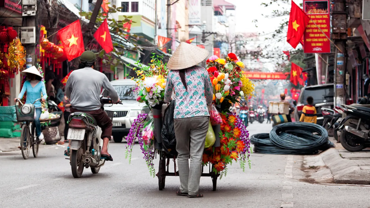 Blomstersælger på en travl gade i Hanoi