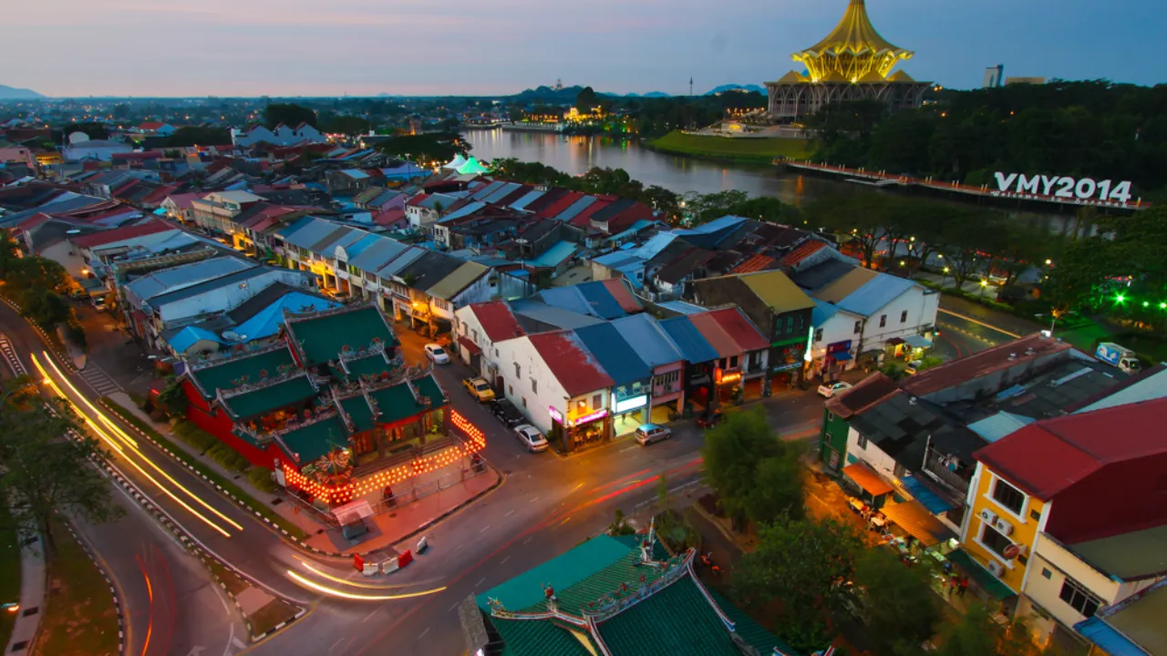 Aftenudsigt over Kuching med byens tage og den karakteristiske Sarawak State Legislative Assembly-bygning i baggrunden Aftenudsigt over Kuching med byens tage og den karakteristiske Sarawak State Legislative Assembly-bygning i baggrunden